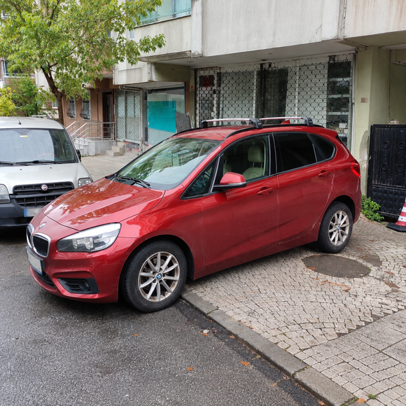 BMW 2 Series Active Tourer F45 2014-2021 with black roof rack cross bars installed on flush integrated roof rails