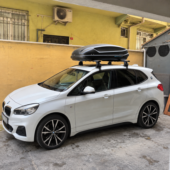 BMW 2 Series Active Tourer F45 2014-2021 with silver roof rack cross bars installed on a normal bare roof with no factory rails