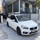 BMW 2 Series Gran Tourer F46 2014-2021 with silver roof rack cross bars installed on a normal bare roof with no factory rails