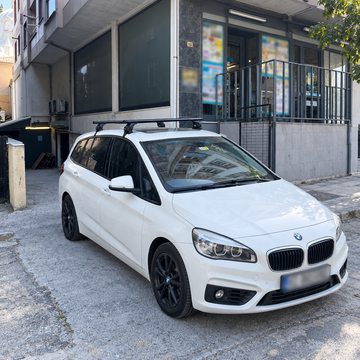 BMW 2 Series Gran Tourer F46 2014-2021 with black roof rack cross bars installed on a normal bare roof with no factory rails