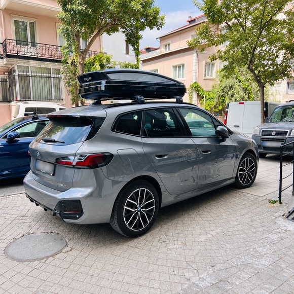 BMW 2 Series Active Tourer U06 2022-Up with black roof rack cross bars installed on flush integrated roof rails