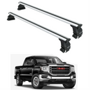 Two car roof racks with a black GMC truck in the background