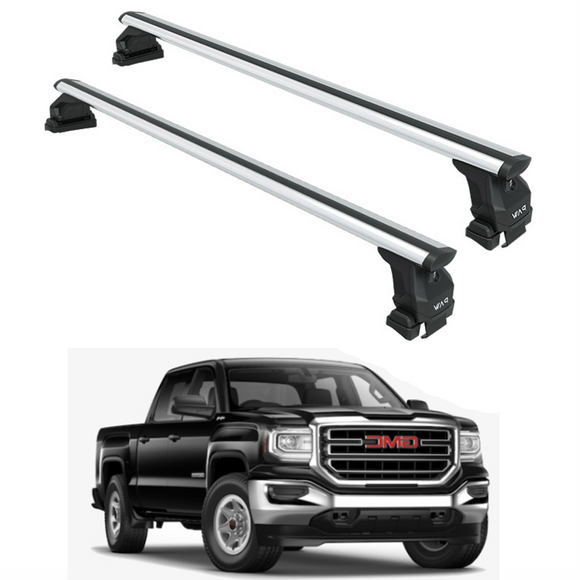 Two car roof racks with a black GMC truck in the background