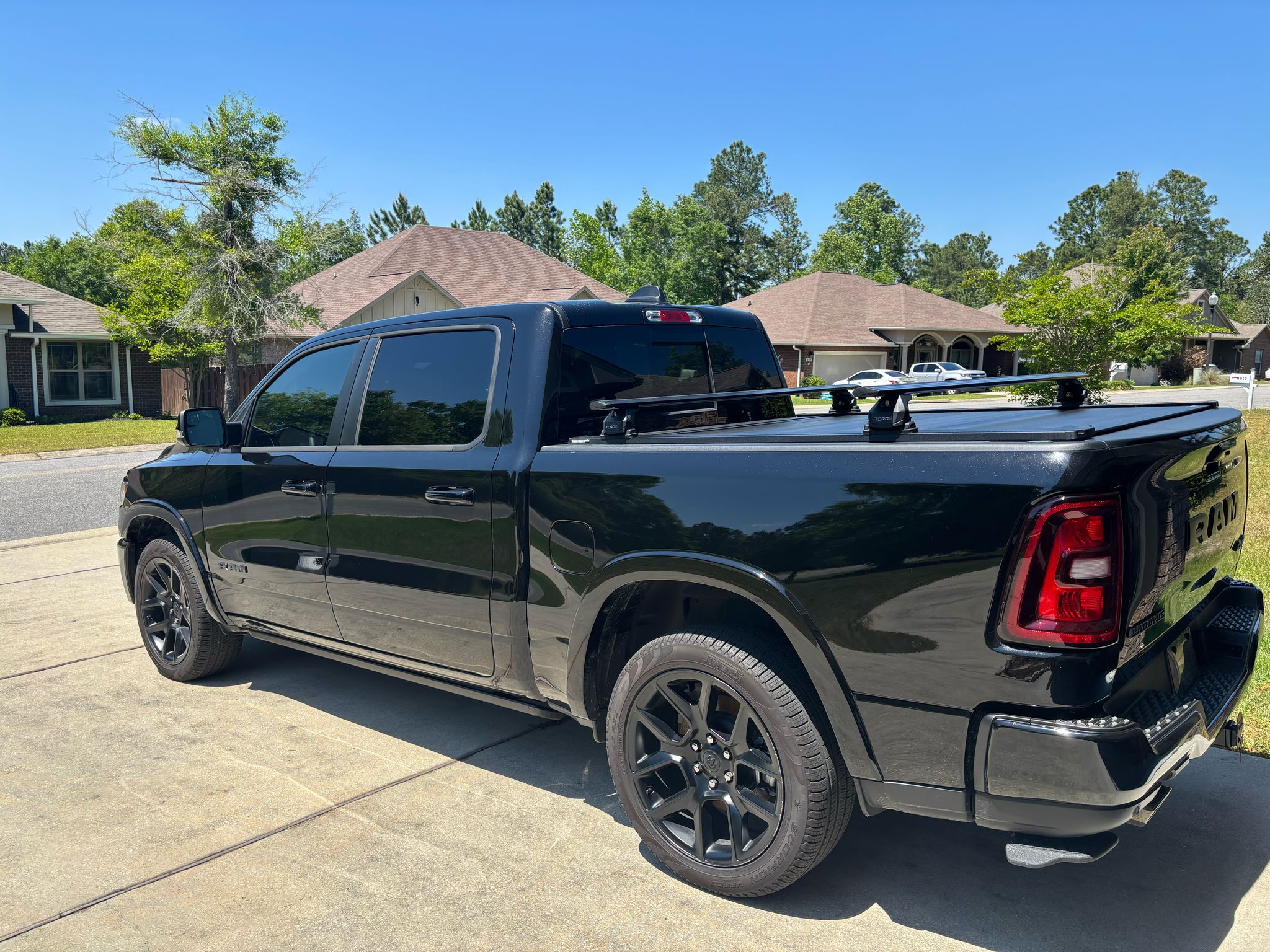 For RAM 1500 (2009-2025) Bed Rack Cross Bars with Metal Brackets (Aluminum, Black) + RealTruck Tonneau Cover w/ T-Slot Rails