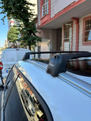 Car roof rack with 'PAW' branding on a vehicle parked on a street.